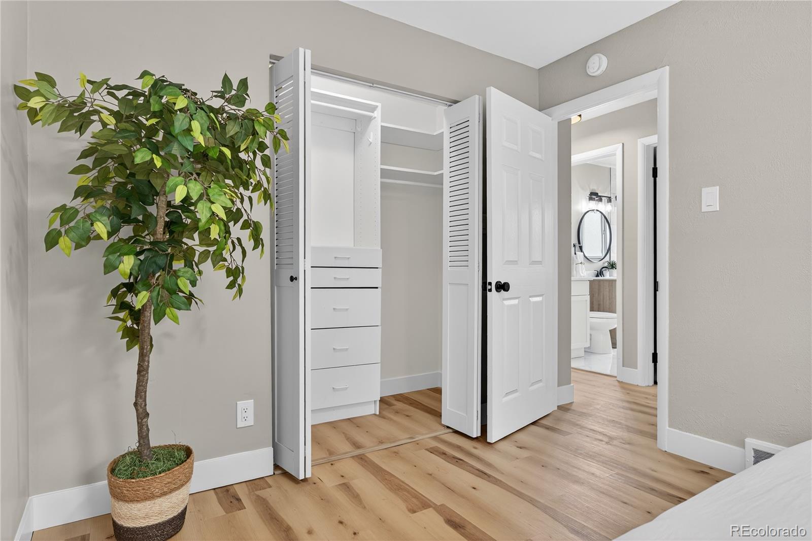 4910 East Missouri Avenue Denver, CO 80246 - Photo 31 of 42 a view of a hallway with wooden floor and potted plant