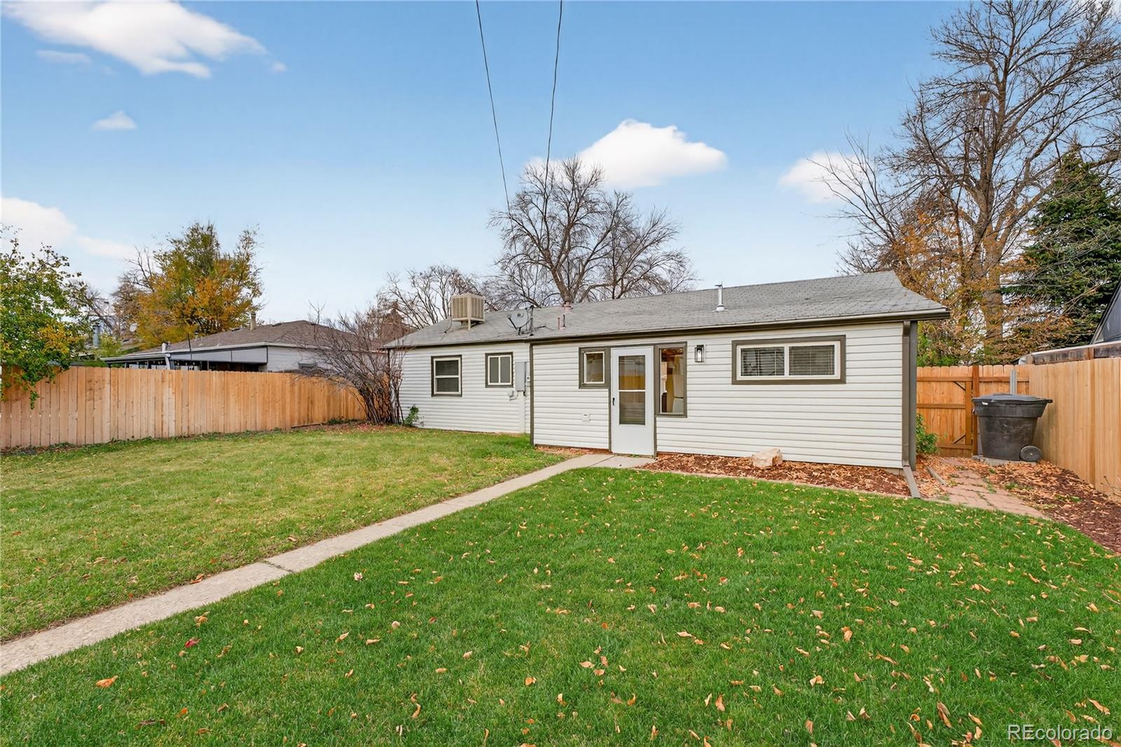 4910 East Missouri Avenue Denver, CO 80246 - Photo 33 of 42 a front view of a house with a garden and yard