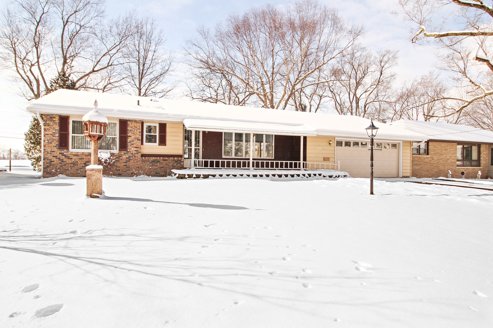 3122 River Road Kankakee, IL 60901 - Photo 1 of 15 a front view of a house with a yard covered with snow