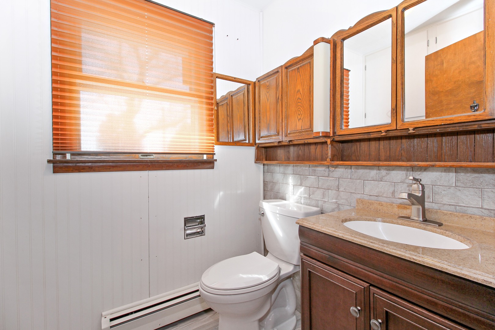 3122 River Road Kankakee, IL 60901 - Photo 12 of 15 a bathroom with a toilet a sink and a window