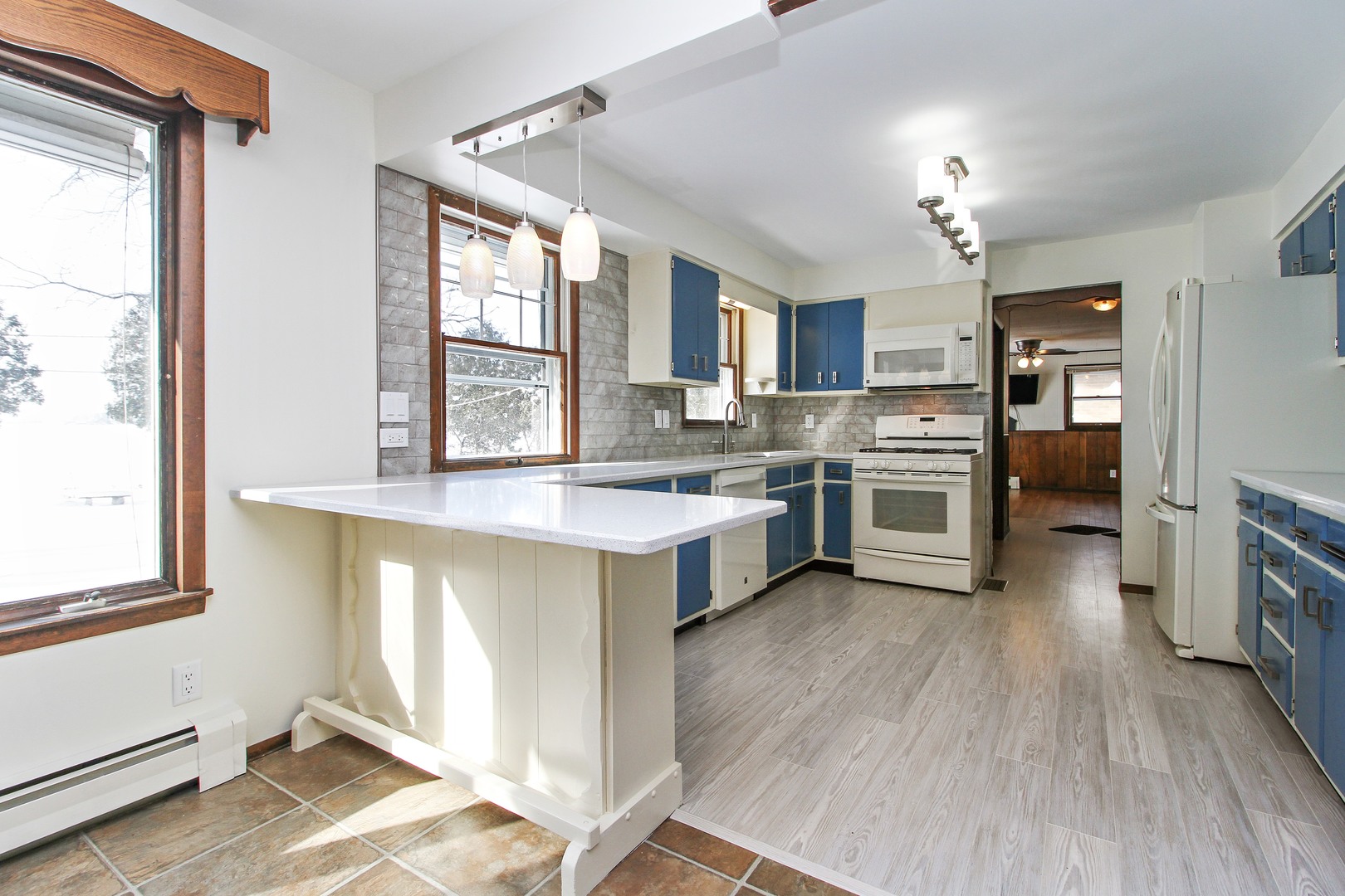 3122 River Road Kankakee, IL 60901 - Photo 5 of 15 a large kitchen with a large window a sink and stainless steel appliances