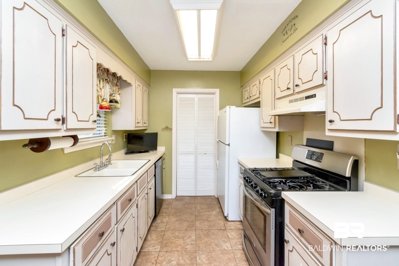 9360 Burnt Tree Drive Mobile, AL 36695 - Photo 4 of 28 Kitchen with white cabinets, stainless steel appliances, and sink