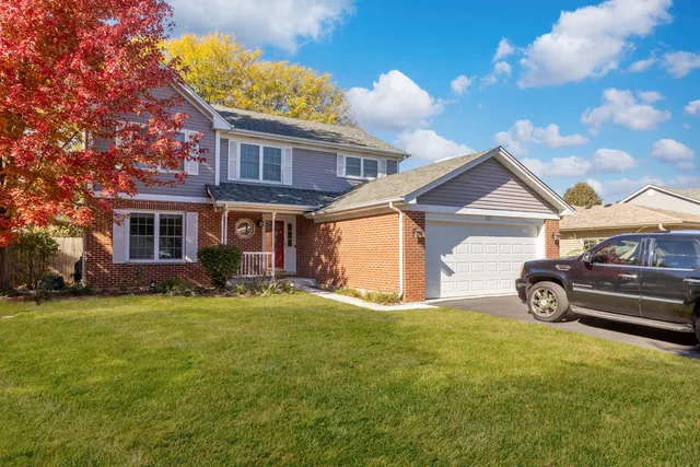 a view of a house with a yard and garage