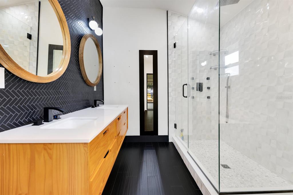 344 Starling Road Winter Park, FL 32789 - Photo 24 of 43 a bathroom with a double vanity sink and a mirror