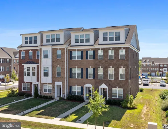 a front view of a residential apartment building with a yard