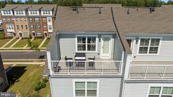 a large kitchen with kitchen island a large counter top space a sink stainless steel appliances and cabinets