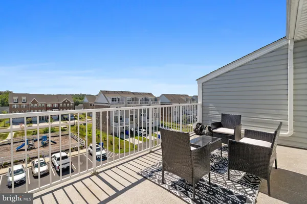 a kitchen with granite countertop a stove a sink and a refrigerator