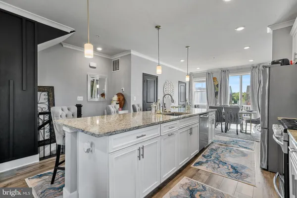 a view of a hallway to a dining room with shelves