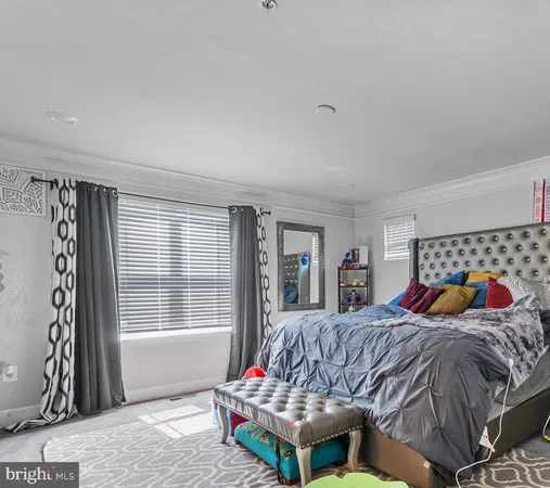a living room with furniture a fireplace and a window