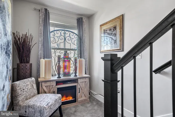 a bedroom with furniture and a large window