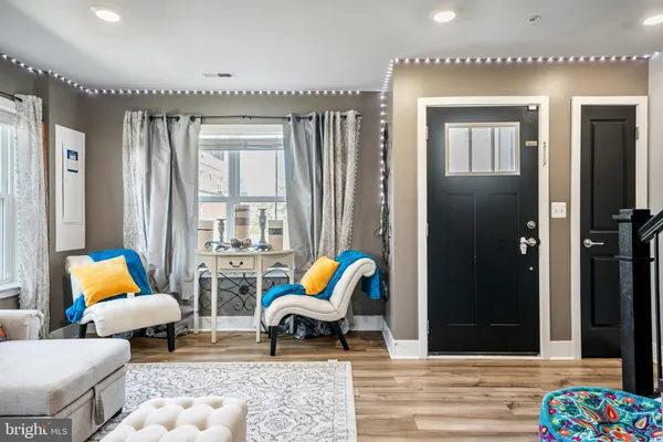 a living room with furniture and floor to ceiling windows