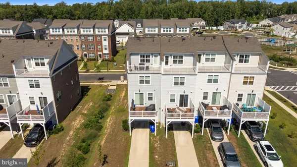 a balcony with table and chairs and wooden fence