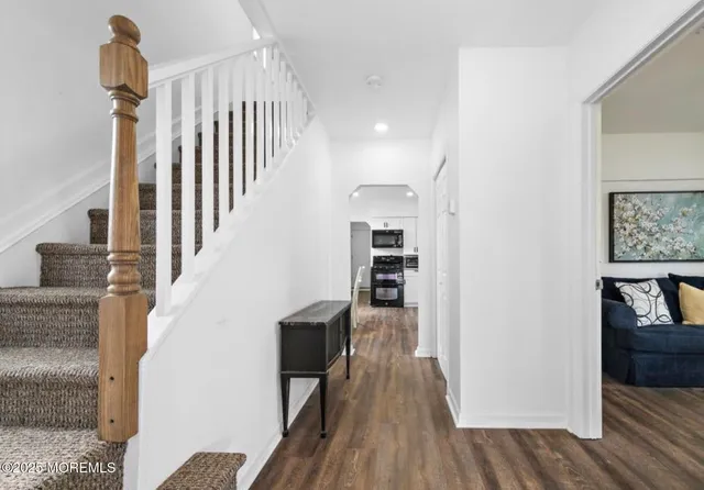 a view of entryway and hall with wooden floor