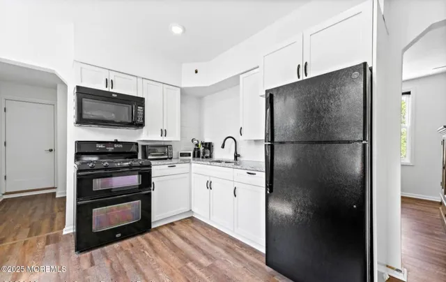 a kitchen with stainless steel appliances a refrigerator stove and sink