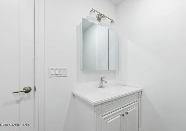 a bathroom with a sink and mirror