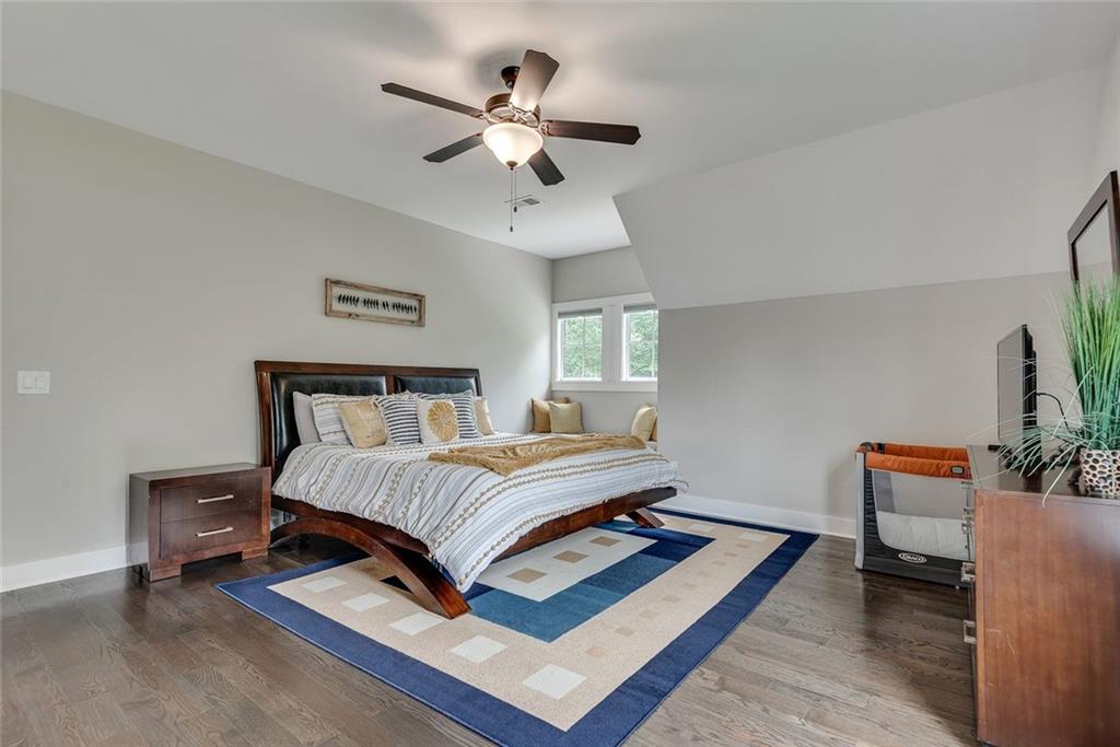 2503 Sugar Pike Road Canton, GA 30115 - Photo 107 of 134 a bedroom with a bed lamp and a chandelier
