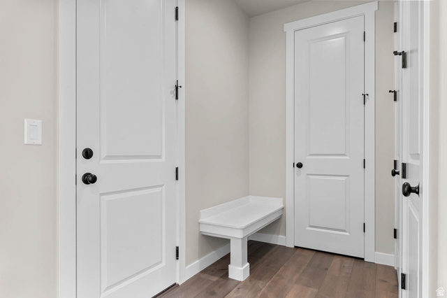 1567 North 3250 West Provo, UT 84601 - Photo 6 of 22 Entryway featuring light neutral wall paint, wood-finish flooring, white doors with dark hardware, and a built-in white bench