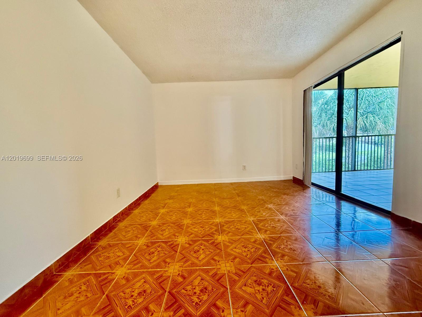 3470 Foxcroft Road, Unit 204 Miramar, FL 33025 - Photo 16 of 40 wooden floor in an empty room with a window