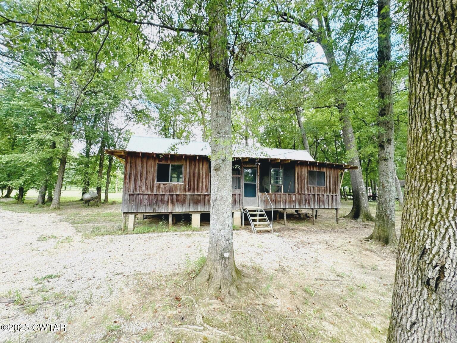 135 River Bend Road Brownsville, TN 38012 - Photo 4 of 14 a backyard of a house with table and chairs