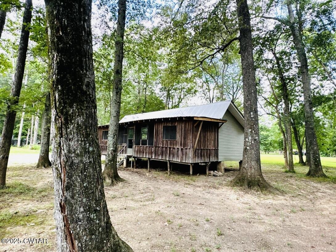 135 River Bend Road Brownsville, TN 38012 - Photo 5 of 14 a backyard of a house with lots of trees and entertaining space