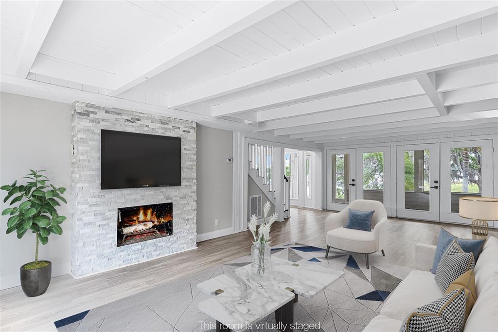 311 East 8th Avenue Windermere, FL 34786 - Photo 11 of 59 a living room with furniture a flat screen tv and a fireplace