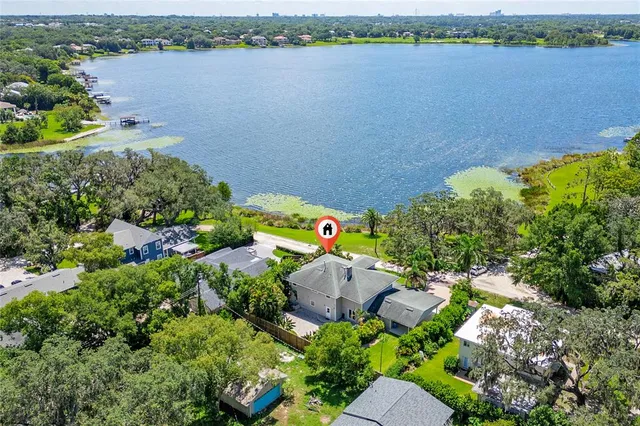 a view of a kitchen counter space with a sink and dishwasher with wooden floor