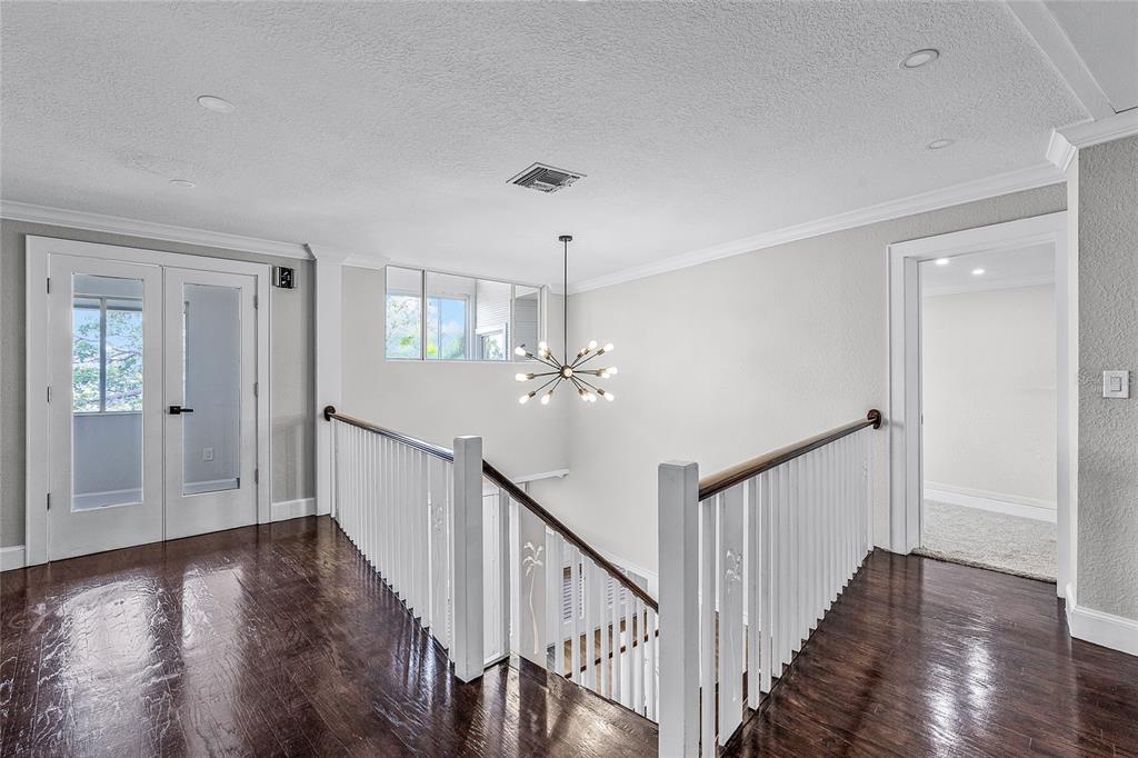 311 East 8th Avenue Windermere, FL 34786 - Photo 28 of 59 a view of a hallway with wooden floor and staircase