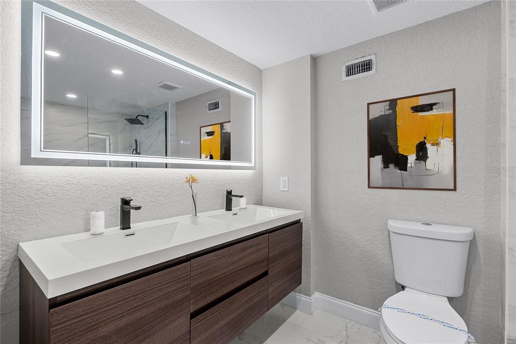 311 East 8th Avenue Windermere, FL 34786 - Photo 34 of 59 a bathroom with a toilet sink and mirror