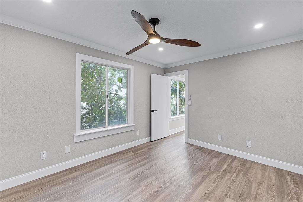 311 East 8th Avenue Windermere, FL 34786 - Photo 38 of 59 an empty room with wooden floor fan and windows