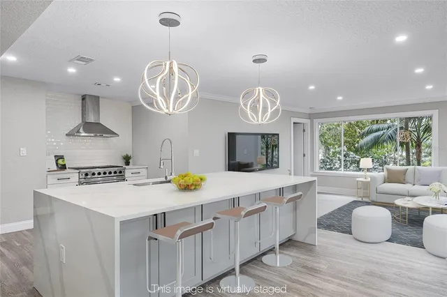 a kitchen with a sink a stove and a refrigerator