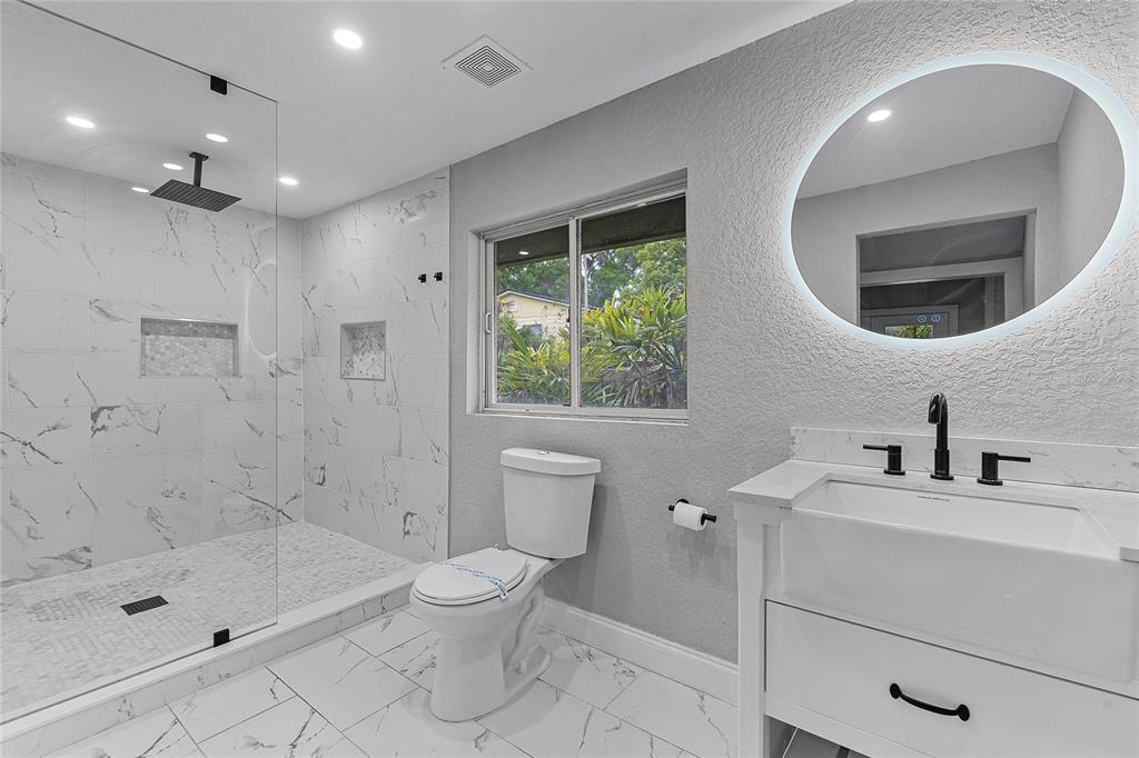 311 East 8th Avenue Windermere, FL 34786 - Photo 41 of 59 a bathroom with a sink a toilet and shower