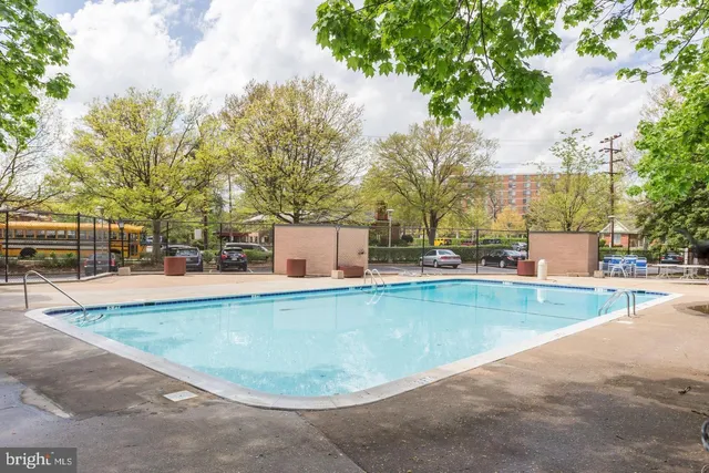 a view of a swimming pool with a bench