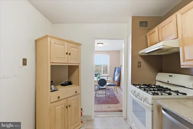 a kitchen with cabinets and a stove top oven