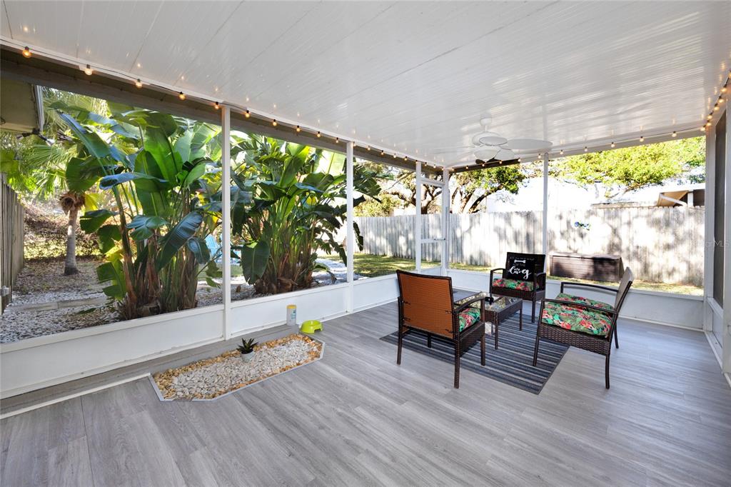 5596 100th Way North St. Petersburg, FL 33708 - Photo 54 of 67 a living room with patio furniture and a potted plant