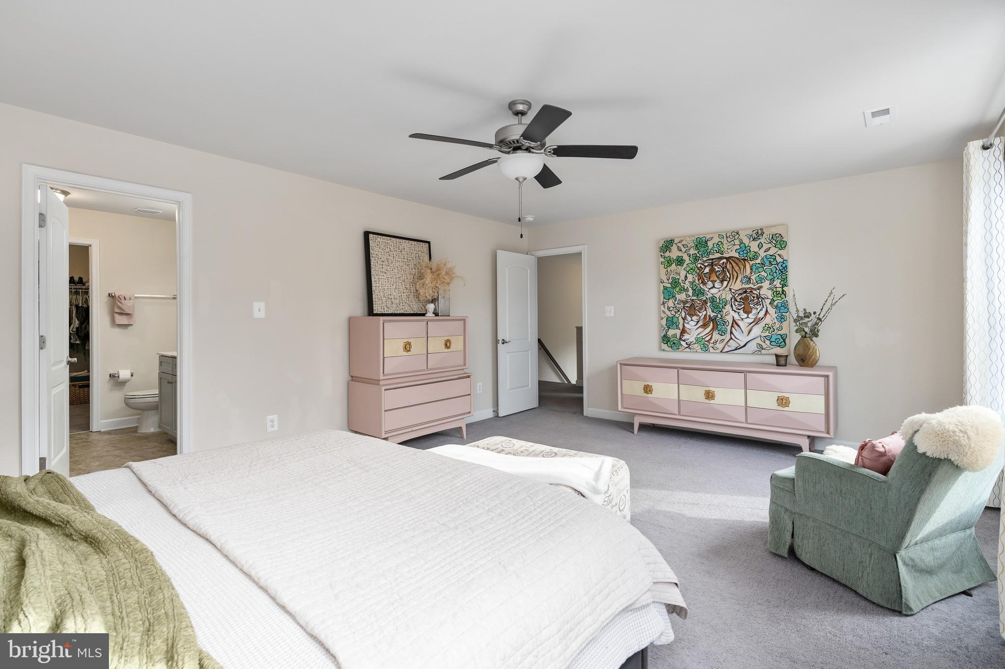 109 12th Street Colonial Beach, VA 22443 - Photo 12 of 33 a spacious bedroom with a bed a couch and a window