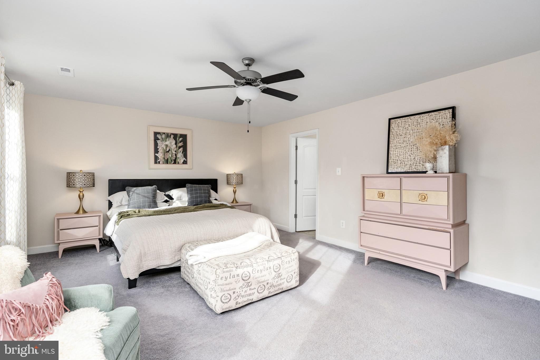 109 12th Street Colonial Beach, VA 22443 - Photo 13 of 33 a spacious bedroom with a bed and cabinet