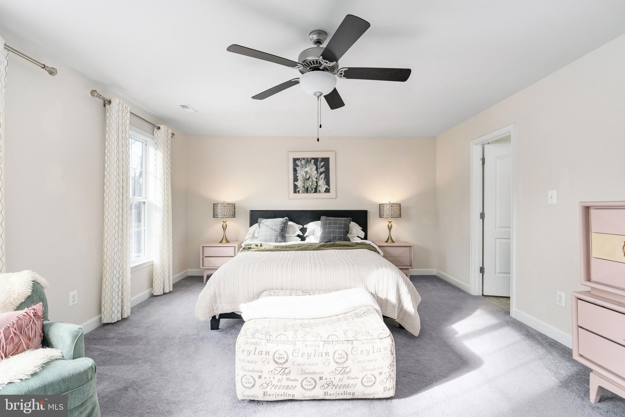 109 12th Street Colonial Beach, VA 22443 - Photo 14 of 33 a bed room with a bed and a ceiling fan