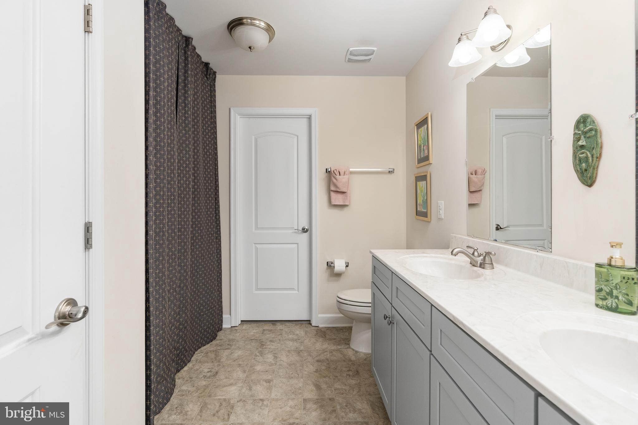 109 12th Street Colonial Beach, VA 22443 - Photo 15 of 33 a bathroom with a sink a light fixture and a mirror