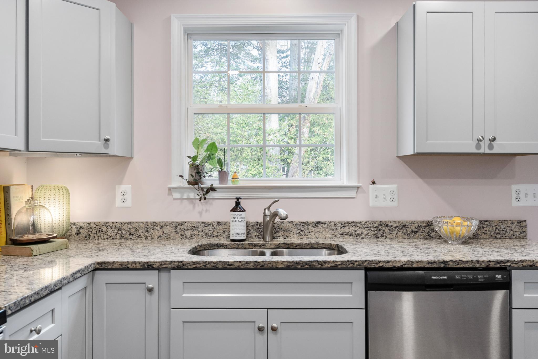 109 12th Street Colonial Beach, VA 22443 - Photo 2 of 33 a kitchen with granite countertop white cabinets and a window