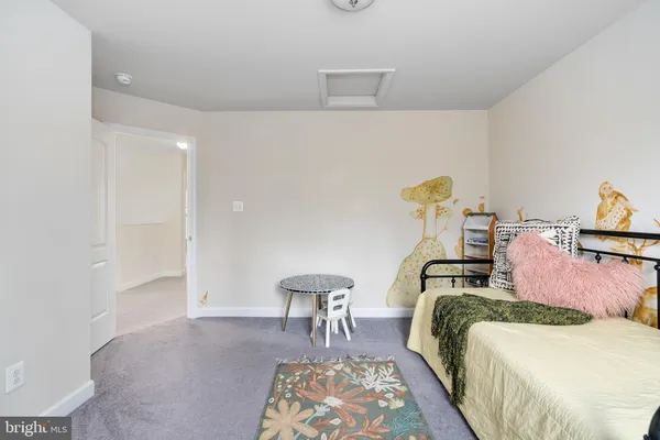 a bedroom with bed and chair