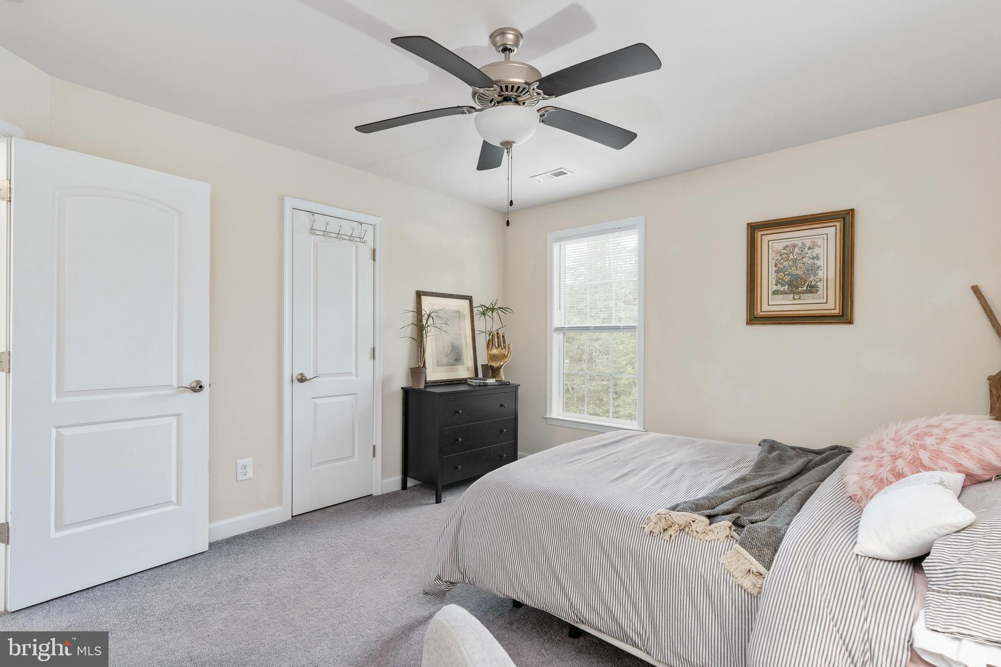 109 12th Street Colonial Beach, VA 22443 - Photo 26 of 33 a bedroom with a bed and a chandelier