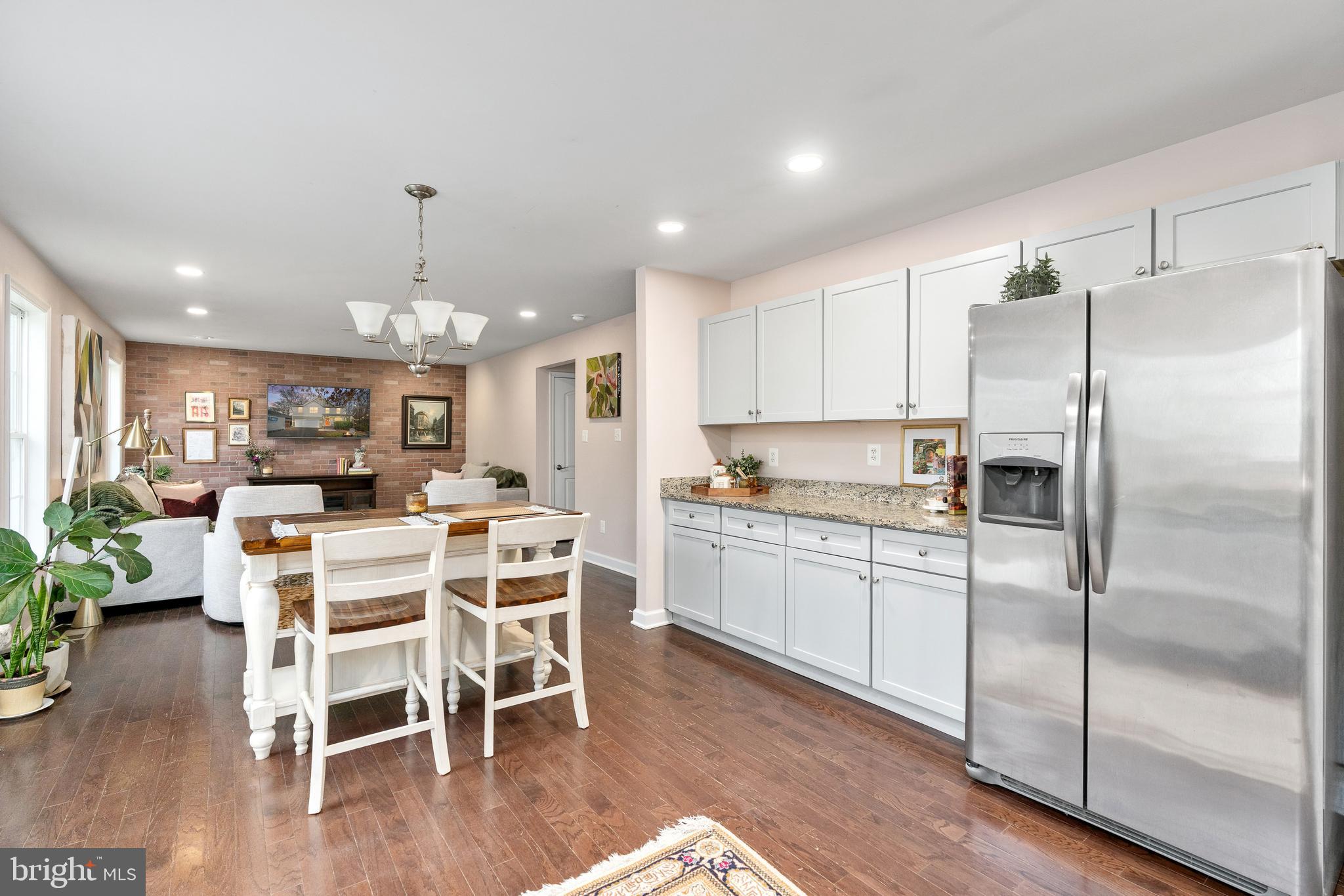 109 12th Street Colonial Beach, VA 22443 - Photo 4 of 33 a kitchen with microwave a refrigerator and chairs