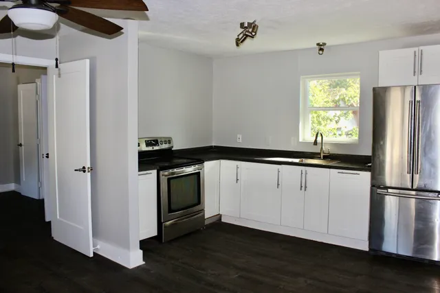 a kitchen with a refrigerator and window