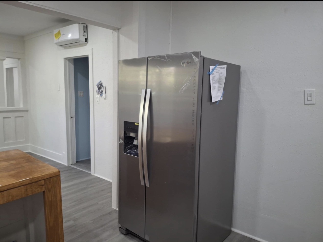 1009 Thomas Boulevard Port Arthur, TX 77640 - Photo 12 of 14 a view of a refrigerator in kitchen and wooden floor