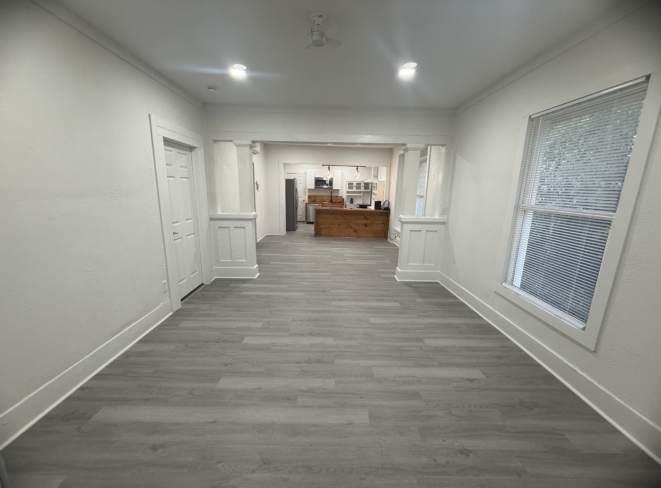 1009 Thomas Boulevard Port Arthur, TX 77640 - Photo 10 of 14 a view of a hallway with wooden floor and a bathroom