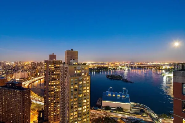 a view of a ocean with boats and trees