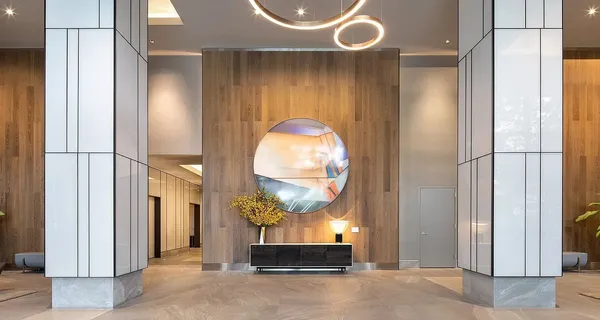 a room with lots of tables a large window and chairs