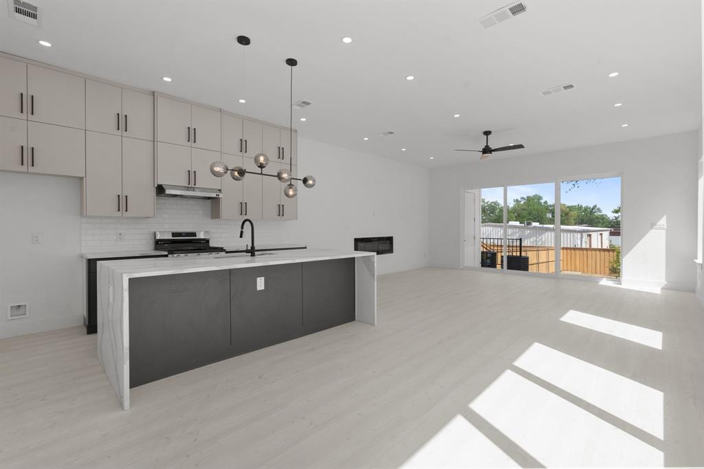 1849 Pollard Street Dallas, TX 75208 - Photo 10 of 10 a large kitchen with stainless steel appliances kitchen island a large counter top and a stove