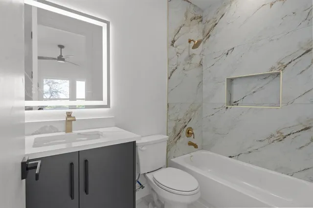 a view of a livingroom with a ceiling fan a ceiling fan and windows