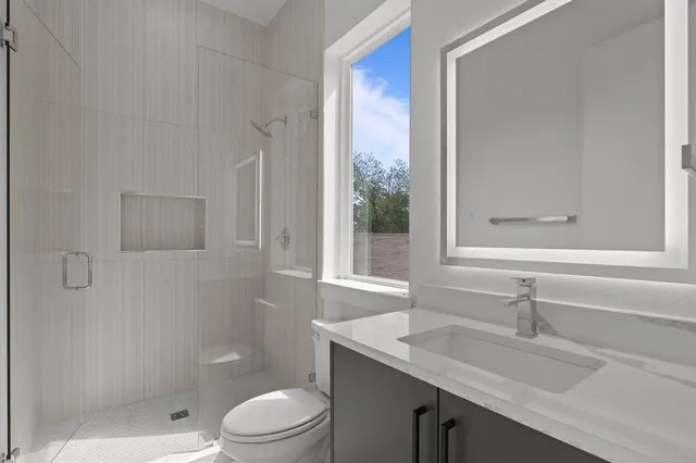 a bathroom with a sink toilet vanity and bathtub